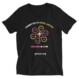 May include: Black V-neck t-shirt with a graphic design. The design includes the words "COMMITTED TO SOCIAL JUSTICE" and "CENTERED IN LOVE". The graphic features a stylized flower with the word "LOVE" at the center and the website gnouu.org.
