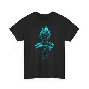 May include: Black t-shirt featuring a teal graphic of a character with spiky hair and crossed arms. A smaller figure is below the main image. The design is a stylized illustration, likely from an anime or manga series.
