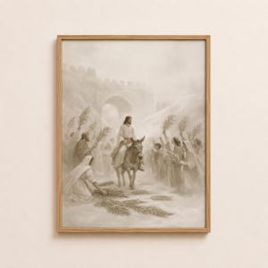 May include: A sepia-toned framed print depicts a religious scene. A figure rides a donkey, surrounded by people holding palm branches. The artwork has a soft, diffused light, creating a serene atmosphere. The scene is set against a backdrop of an archway and a distant structure.