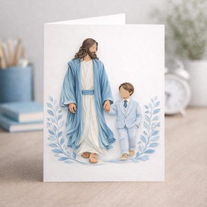 May include: A white greeting card featuring a paper relief of a figure in a blue robe holding hands with a young boy in a blue suit. The card is decorated with blue leaf accents.