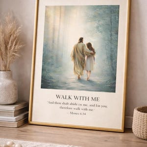 May include: Framed art print featuring a serene depiction of two figures walking together in a forest. The artwork has a gold frame and includes the text "WALK WITH ME" and a Bible verse. The overall color palette is soft and natural.