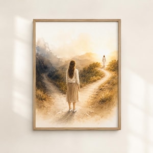 May include: A framed watercolor print depicting a person with long brown hair wearing a white long-sleeved top and a tan skirt standing on a dirt path that forks into two directions. In the distance, a figure in white walks along the right path.