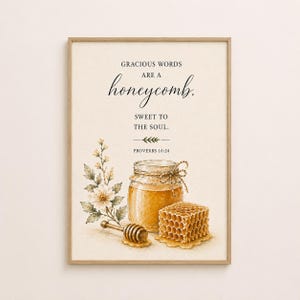 May include: A framed watercolour print showing a jar of honey, a honeycomb, and a honey dipper. The text reads "Gracious words are a honeycomb, sweet to the soul. Proverbs 16:24." The artwork includes floral and leaf accents.