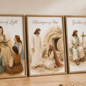 May include: Three framed art prints with religious themes. The prints feature illustrations of biblical scenes with figures in robes. The first print reads "Gatherers of Light", the second "Messengers of Hope", and the third "Builders of Faith". The frames are a light brown color.