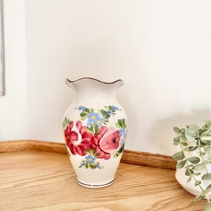 May include: A set of three ceramic mugs with a speckled, matte finish. The mugs are in shades of cream, light gray, and dark gray. Each mug has a simple, minimalist design and a rounded handle. Perfect for coffee or tea.