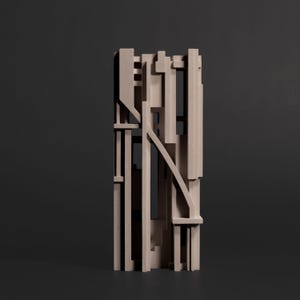 May include: A vertical sculpture composed of light beige, matte-finished rectangular blocks and beams arranged in a complex, layered geometric structure with various open spaces and intersecting lines creating a multi-dimensional, grid-like appearance.
