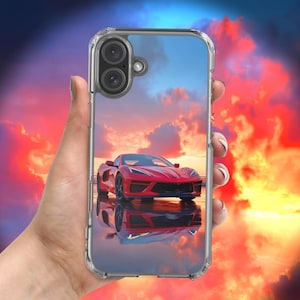 Pode incluir: Capa de telefone transparente com um carro esportivo vermelho em um cenário de pôr do sol. O carro é refletido em uma superfície brilhante. O céu é uma mistura de azul, laranja e vermelho.