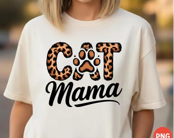 May include: Cream-colored t-shirt featuring the text "Cat Mama" in black script. The word "Cat" is designed with a leopard print pattern, and the letter "O" is replaced with a cat paw print.