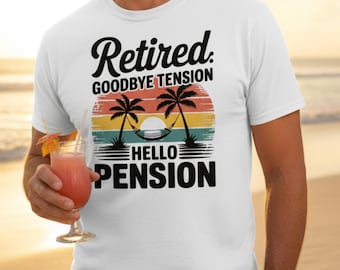 May include: White t-shirt with the words "Retired Goodbye Tension Hello Pension" in black script. The design includes a sunset with palm trees and a hammock. The person is holding a cocktail.