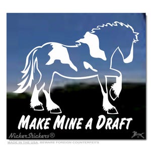 May include: White silhouette of a draft horse with a black and white spotted coat. The horse is standing with its right leg raised. The text "Make Mine a Draft" is below the horse.