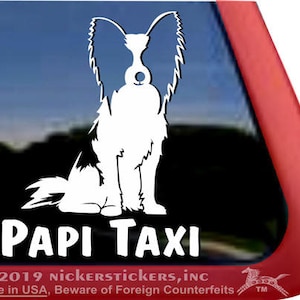 May include: White silhouette of a Papillon dog sitting with its ears up. The text "PAPI TAXI" is below the dog.