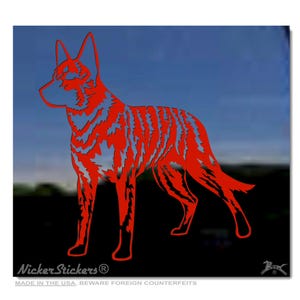 May include: Red silhouette of a dog, possibly a Dingo, standing on a black background. The silhouette is detailed with a textured pattern. The image includes the text "Nicker Stickers" and "Made in the USA. Beware foreign counterfeits."