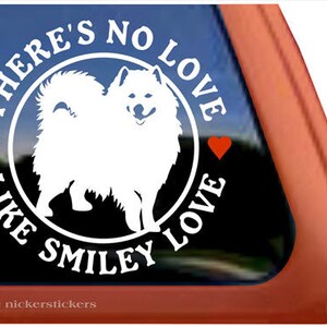 May include: White silhouette of a Pomeranian dog in a circle with the text "There's no love like Smiley Love" and two red hearts.