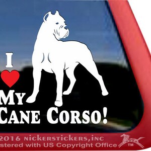 May include: White vinyl decal with a Cane Corso dog silhouette and the text "I ❤️ My Cane Corso!". The design includes a red heart on a black background. Copyright information is at the bottom of the decal.