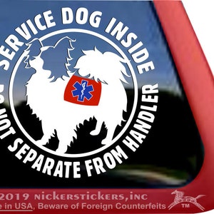 May include: White sticker with black text that reads "Service Dog Inside Do Not Separate From Handler". The sticker features a white silhouette of a dog with a red medical symbol on its chest.