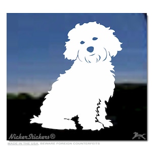 Op de afbeelding: Witte silhouet van een kleine, pluche hond die zit met zijn hoofd lichtjes naar de zijkant gekanteld. De hond kijkt naar voren en heeft een krullend vacht. De achtergrond is een blauwe lucht.