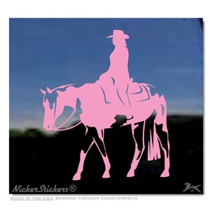 May include: Pink silhouette of a person riding a horse. The horse is in a walking position with its head turned to the left. The person is wearing a cowboy hat and is sitting in a western saddle. The image is on a black background.