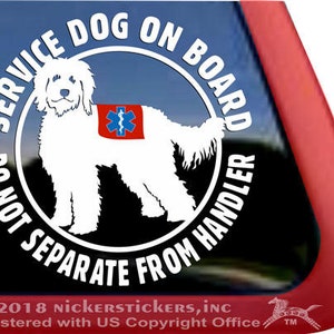 May include: White service dog decal with a red, blue, and white medical symbol on its back. The decal is round and has the text "Service Dog On Board Do Not Separate From Handler" in white lettering on a black background.