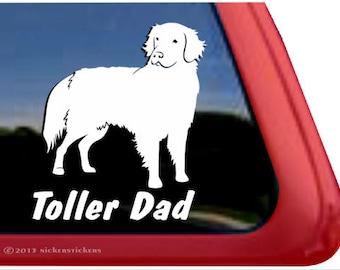 May include: White silhouette of a dog with the text "Toller Dad" on a red background.