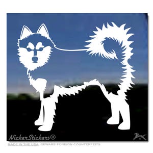 May include: White die-cut sticker of a husky dog in a standing pose. The husky has a fluffy tail and fur, with a blue and white face. The sticker has the text "Nicker Stickers" and "MADE IN THE USA, BEWARE FOREIGN COUNTERFEITS".