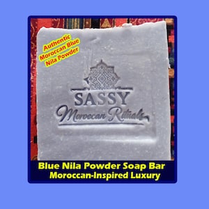 May include: A blue Nila powder soap bar with the text "SASSY Moroccan Rituals". The bar is labeled "Authentic Moroccan Blue Nila Powder" and "Moroccan-Inspired Luxury". The soap has a decorative embossed design.