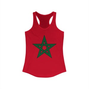 May include: A red racerback tank top featuring a green, five-pointed star in the center. The star has a detailed, interlocking design. The tank top is made of a soft material and has a scoop neck.