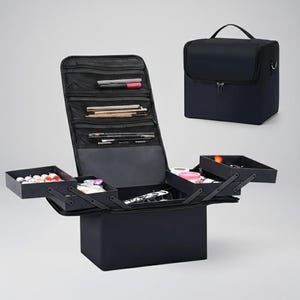May include: Black makeup artist case with multiple compartments, including a fold-out tray and a zipped top. The case is shown open, revealing various makeup items and brushes. A smaller, closed case with a handle is also visible.