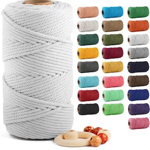 May include: A large white macrame cord spool is shown alongside smaller spools in diverse colours: brown, blue, green, yellow, and pink. Wooden beads and a ring are at the bottom. Suitable for craft projects, this image is a visual guide to materials.