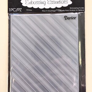 May include: A clear embossing folder with a diagonal striped pattern. The package includes the text "Embossing Essentials" and the brand name "Darice". The folder is designed for creating embossed designs on paper or cardstock.