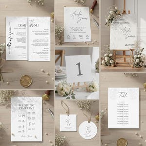 Puede incluir: Una colección de elegante papelería de boda en tonos blancos y grises. Incluye tarjetas de menú, tarjetas de invitación, números de mesa, un letrero de bienvenida y etiquetas. La papelería presenta detalles florales y los nombres "Amelia & James".