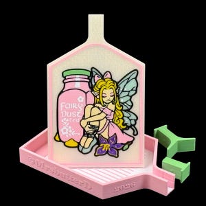May include: A light pink diamond painting tray with a white cover featuring a graphic of a blonde fairy sitting next to a pink jar labeled Fairy Dust tea. The tray has the text MrsbutterD and 2026 embossed on the front edge, accompanied by two small green plastic accessories.