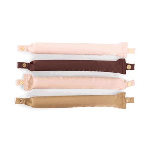 May include: Four fabric hair accessories in shades of pink, brown, and tan. Each cylindrical accessory has a button closure on one end. The accessories are arranged horizontally against a white background.