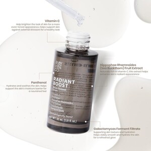 May include: A close-up of a skincare product bottle with a dropper. The bottle is labeled "RADIANT BOOST" and contains ingredients like Vitamin C and Panthenol. The product is dermatologically tested and is 1.01 fl. oz.
