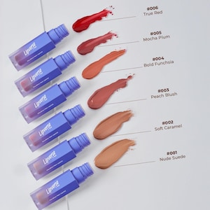 May include: A set of three ceramic mugs with a speckled, cream-colored glaze. Each mug features a different hand-painted floral design in shades of blue, green, and yellow. The mugs have a simple, modern shape.