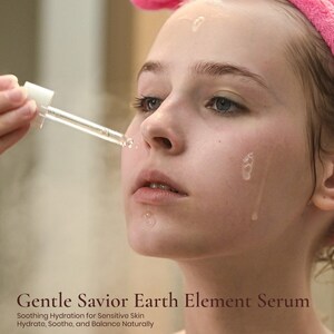 Woman with pink headband using Ruby Vibe Co Gentle Savior Serum, lightweight texture restoring moisture and balance.