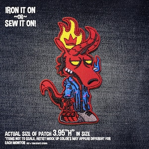 May include: A red cartoon devil patch with a yellow flame crown, wearing a blue jacket. The patch is 3.95 inches high and has the text "IRON IT ON ~OR~ SEW IT ON!".