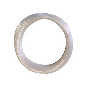 May include: A coil of clear, thin fiber optic cable, arranged in a circular shape. The cable appears to be made of many individual strands, creating a translucent, almost ethereal appearance. The background is plain white.