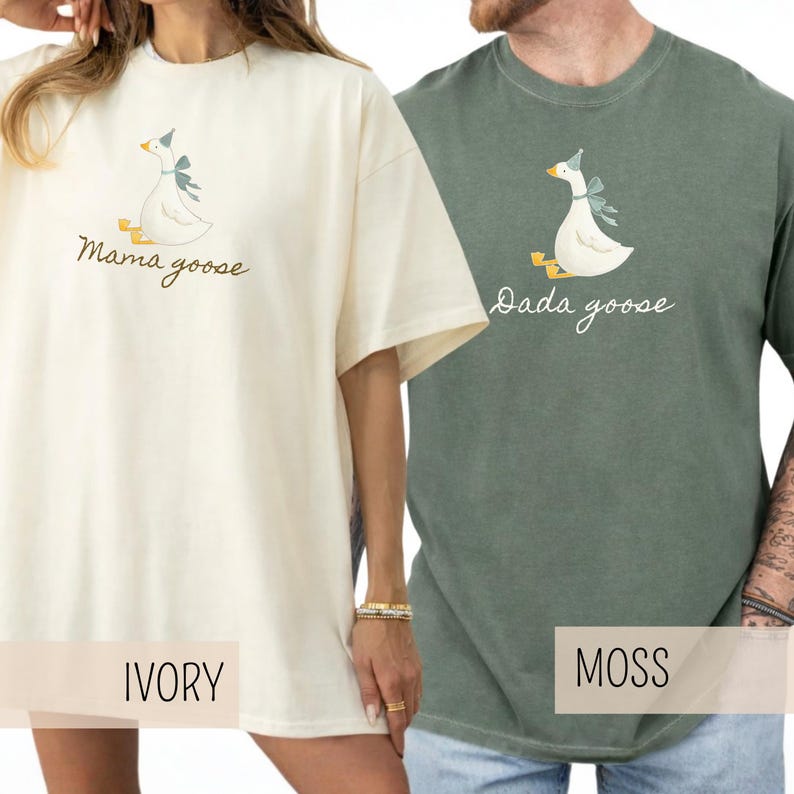 May include: Ivory and moss green t-shirts with goose illustrations. The ivory shirt has "Mama goose" text, and the moss green shirt has "Dada goose" text. Both shirts feature a white goose with a blue bow.