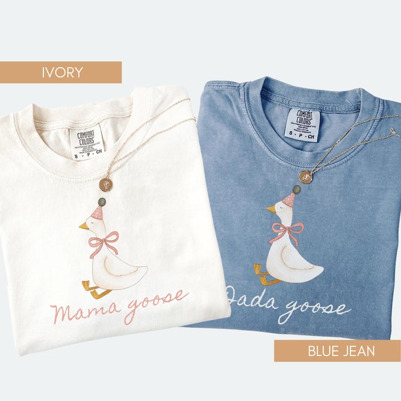 May include: Two t-shirts, one ivory and one blue jean, with goose illustrations. The ivory shirt has "Mama goose" text, and the blue jean shirt has "Dada goose" text. Both shirts have a gold necklace. The shirts are Comfort Colors brand.