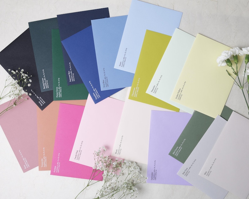 May include: A collection of rectangular paper envelopes in a wide variety of colors including navy, forest green, royal blue, sky blue, lime, pale yellow, dusty rose, fuchsia, candy pink, blush, lavender, sage green, pale gray, and white.