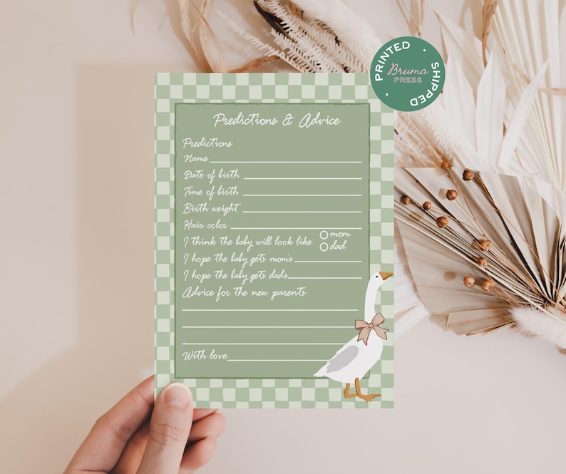 May include: A baby shower game card with a sage green background and a checkered border. The card features a goose illustration with a bow and prompts for predictions and advice. Text includes "Predictions & Advice" and "Printed & Shipped".