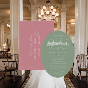 May include: A rectangular pink envelope with white cursive address text paired with an oval sage green wedding invitation featuring a white line drawing of a resort and white cursive text detailing the marriage of Minna Lee Vaughan and Christopher Scudder Terpel.