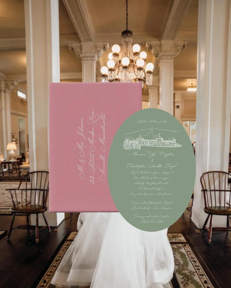May include: A rectangular pink envelope with white cursive address text paired with an oval sage green wedding invitation featuring a white line drawing of a resort and white cursive text detailing the marriage of Minna Lee Vaughan and Christopher Scudder Terpel.