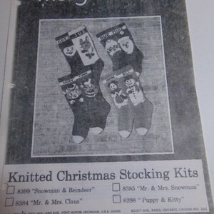 May include: A Mary Maxim pattern booklet for Knitted Christmas Stocking Kits. The cover features four stockings with designs including a snowman, reindeer, and Mr. and Mrs. Claus. Text includes kit numbers 8399, 8384, 8385, and 8398.