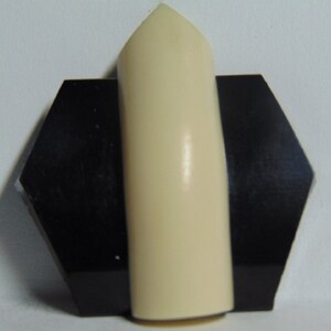 May include: A white, pointed, ceramic finial with a black hexagonal base.