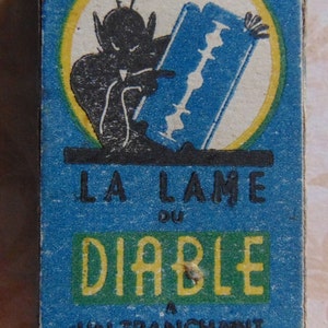 May include: A blue and yellow box with a cartoon devil holding a razor blade. The box says "La Lame du Diable" and "Un tranchant du diable".