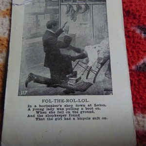 May include: A black and white vintage postcard with an illustration of a person falling while trying on a boot in a shoe shop. The text on the postcard reads: "FOL-THE-ROL-LOL. In a bootmaker's shop down at Luton, A young lady was pulling a boot on, When she fell on the ground, And the shopkeeper found That the girl had a bicycle suit on."