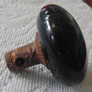 May include: A dark blue ceramic door knob with a rusty metal base. The knob has a smooth, glossy finish.
