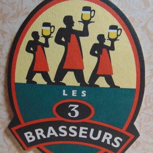May include: A round, green, red, and yellow beer coaster with the text "Les 3 Brasseurs" in black and white. Three cartoon figures are holding beer mugs.