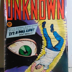 May include: A vintage comic book cover featuring a man falling into a giant eye. The cover is titled "Adventures into the Unknown" and features the text "It's a Dull Life!" in a speech bubble. The comic book is from March 1960.
